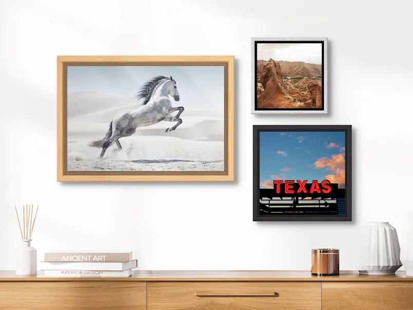 Framed prints on wall above credenza